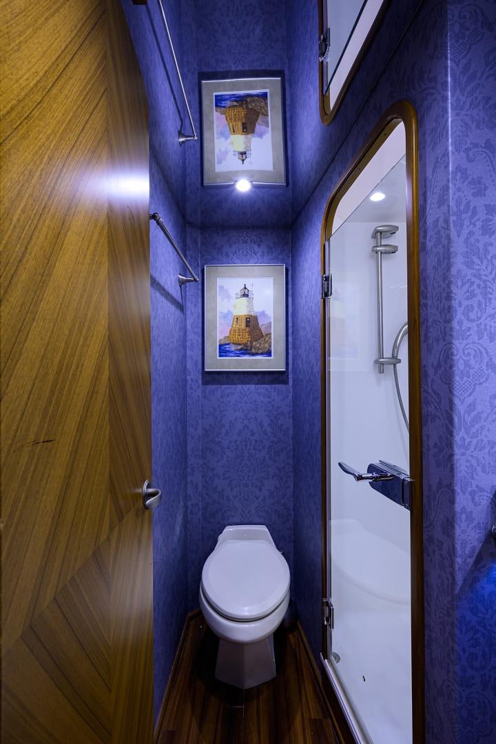 a bathroom with a toilet and a mirror aboard RITE ANGLER Yacht for Sale