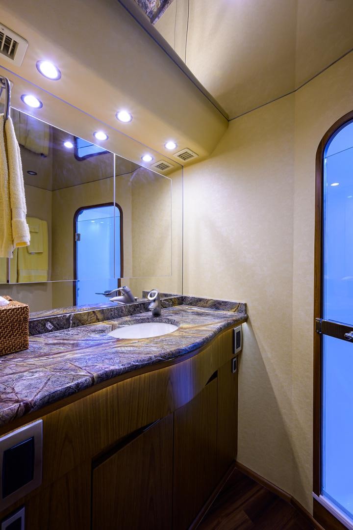 a bathroom with a countertop sink and a mirror aboard RITE ANGLER Yacht for Sale