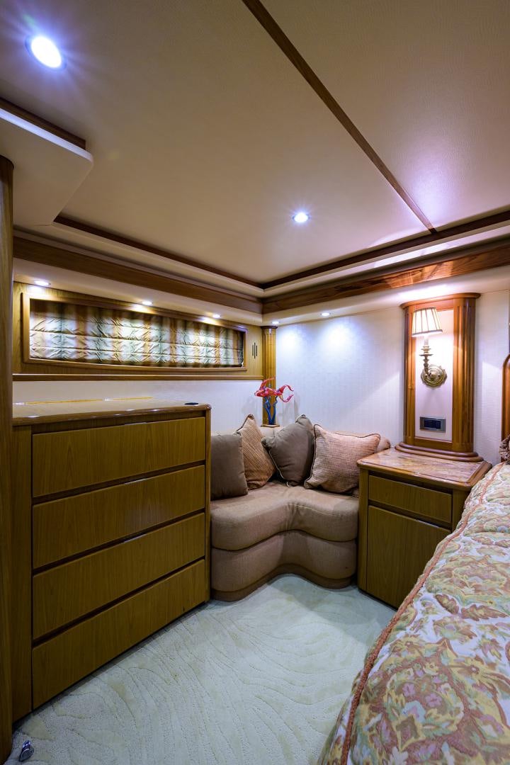 a bedroom with a bed and a dresser aboard RITE ANGLER Yacht for Sale