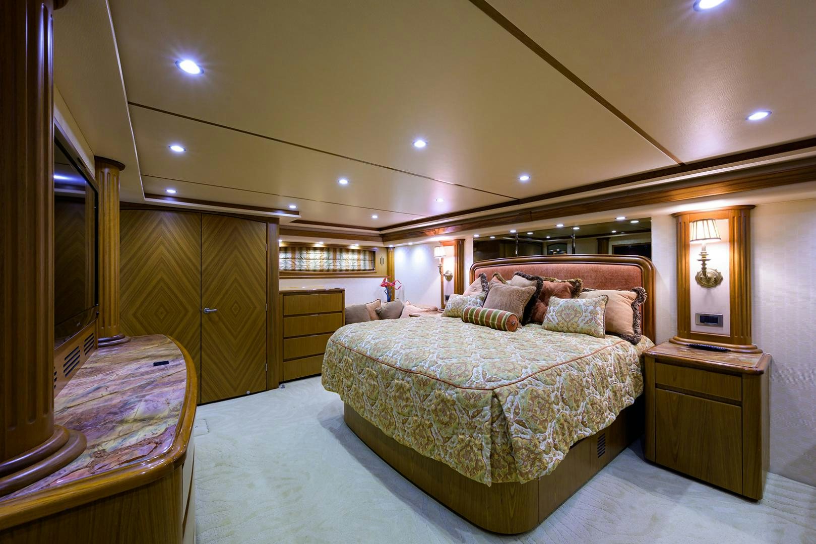 a bedroom with a bed and a mirror aboard RITE ANGLER Yacht for Sale