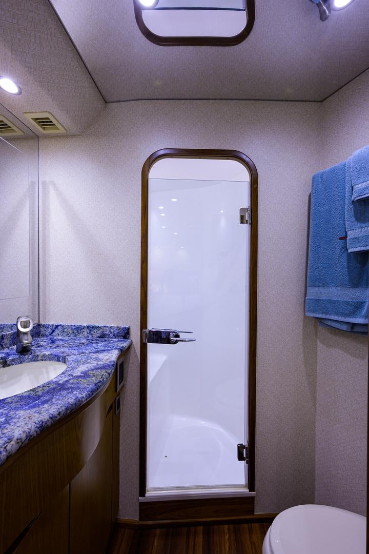 a bathroom with a glass door aboard RITE ANGLER Yacht for Sale