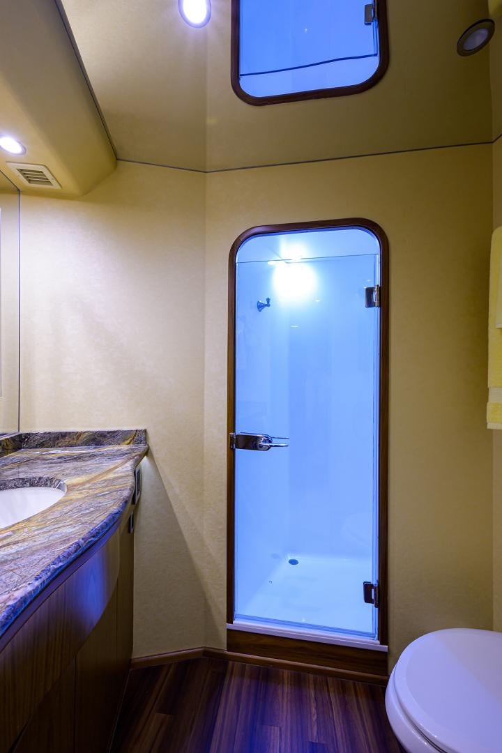 a bathroom with a glass door aboard RITE ANGLER Yacht for Sale