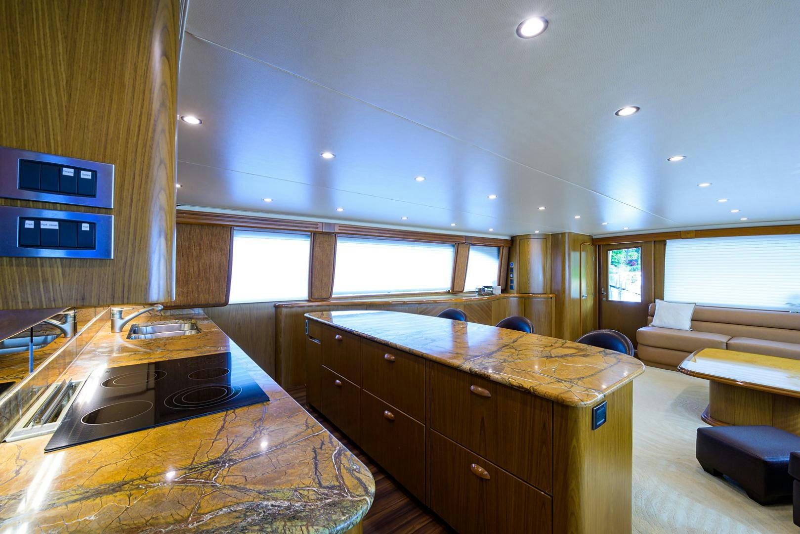 a living room with a table and couches aboard RITE ANGLER Yacht for Sale