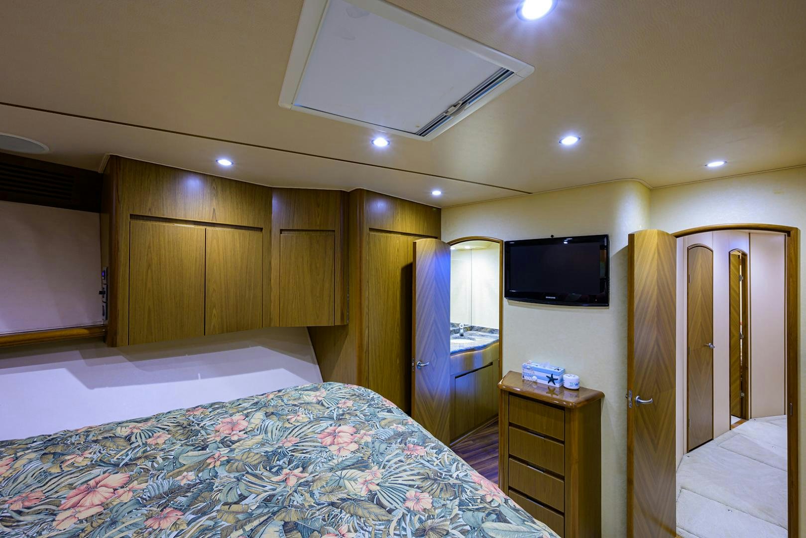 a bedroom with a bed and a television aboard RITE ANGLER Yacht for Sale