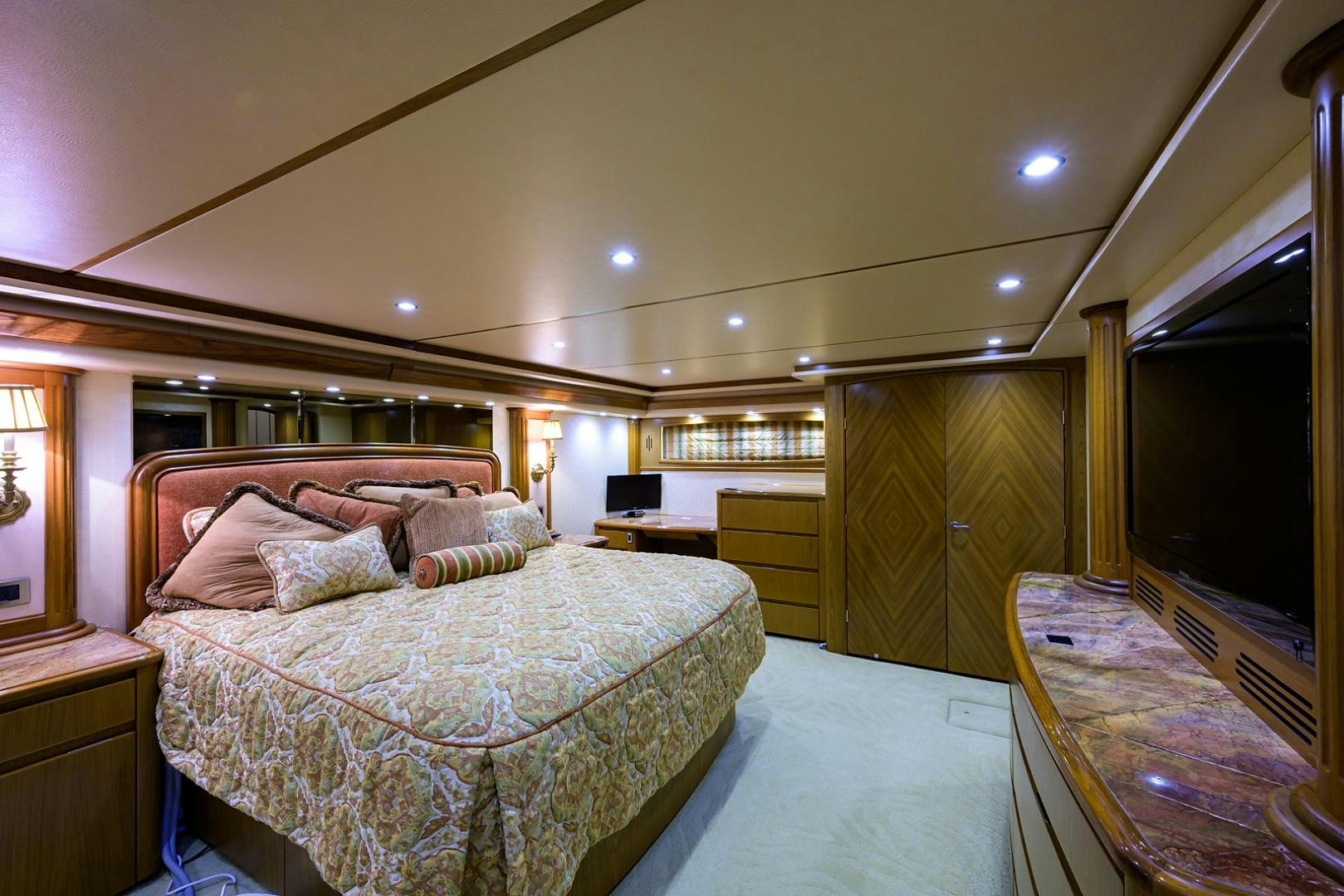 a bedroom with a bed and a table aboard RITE ANGLER Yacht for Sale