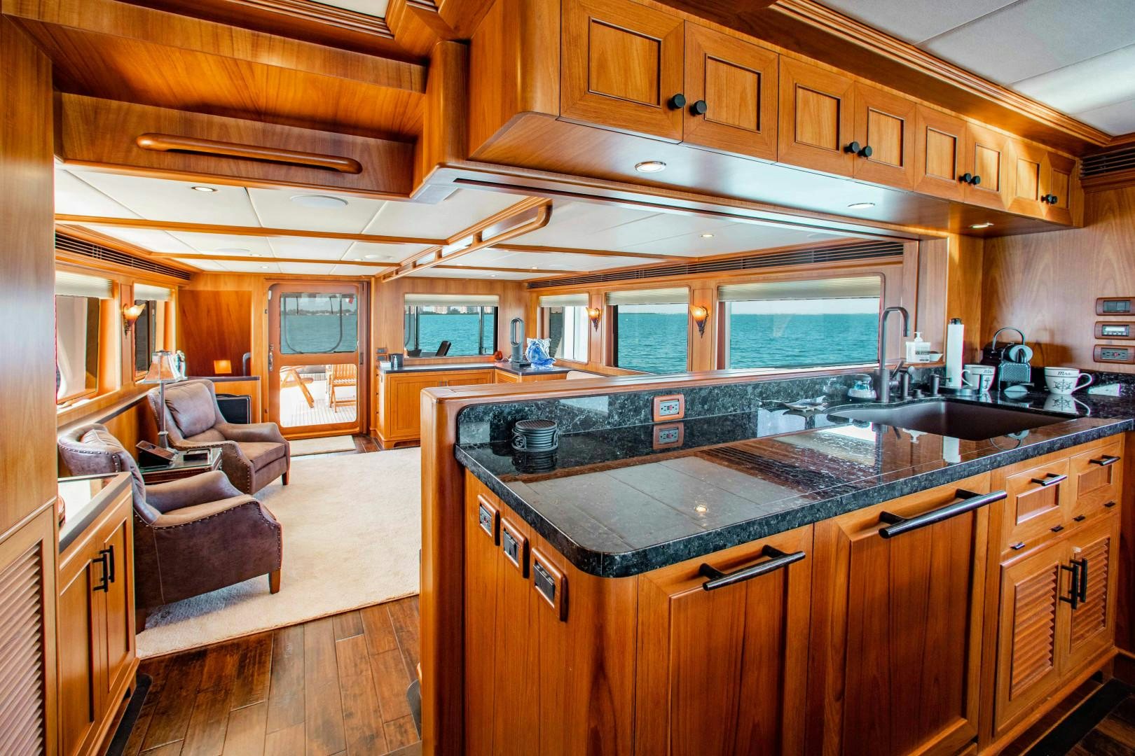 a kitchen with wooden cabinets aboard BARBARA SUE II Yacht for Sale