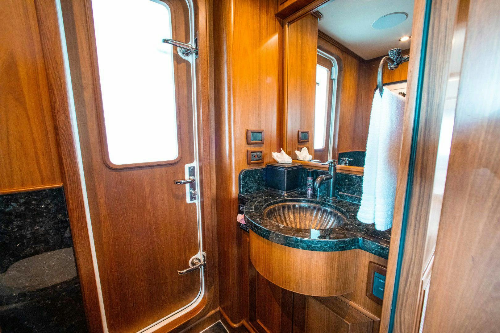 a bathroom with a sink and a mirror aboard BARBARA SUE II Yacht for Sale