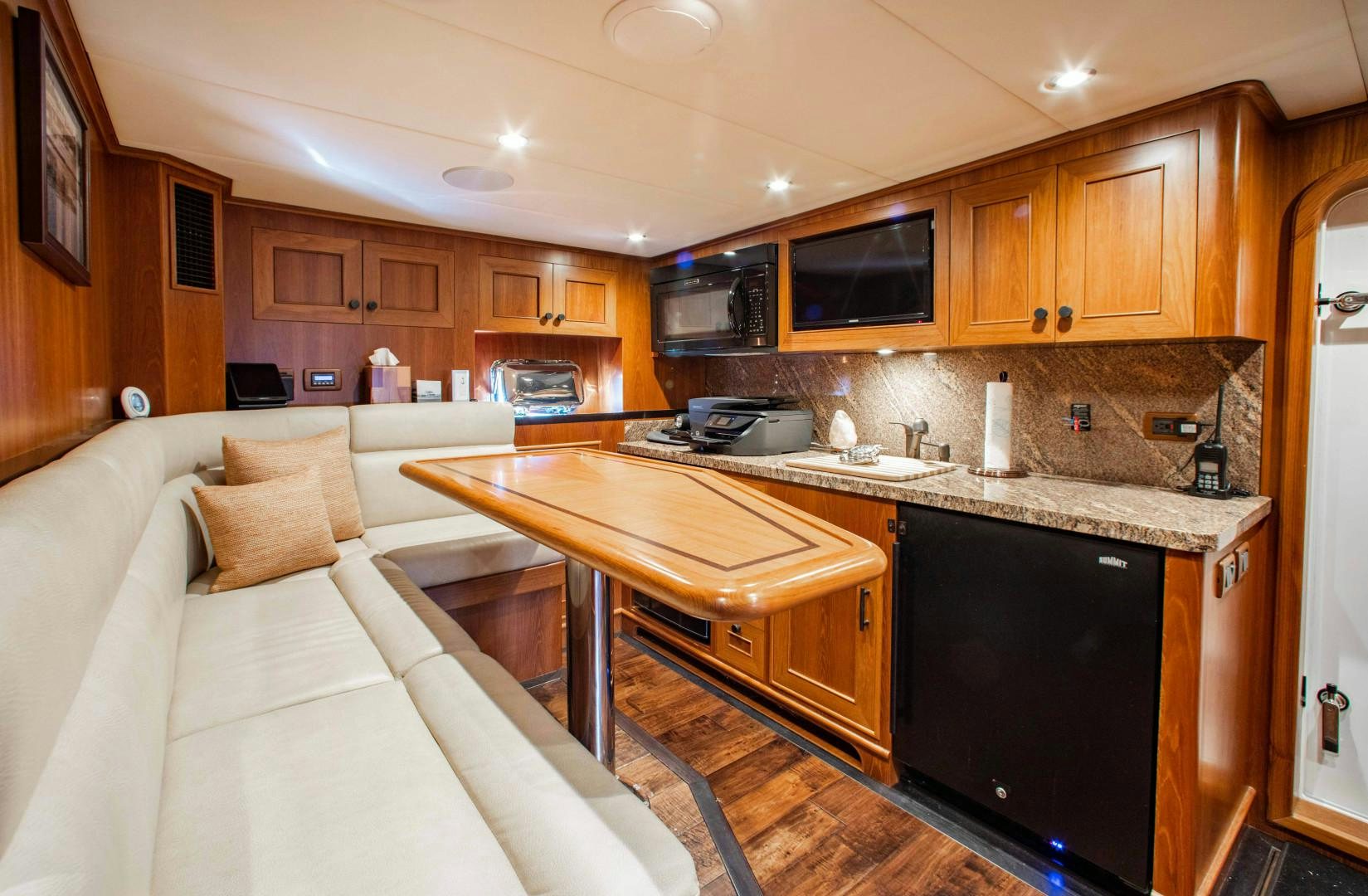 a kitchen with a table and a couch aboard BARBARA SUE II Yacht for Sale