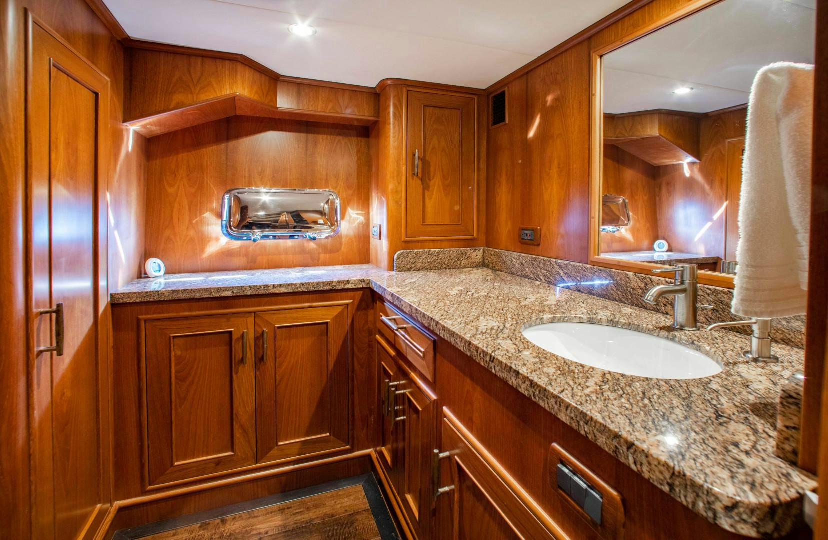 a bathroom with a sink and cabinets aboard BARBARA SUE II Yacht for Sale