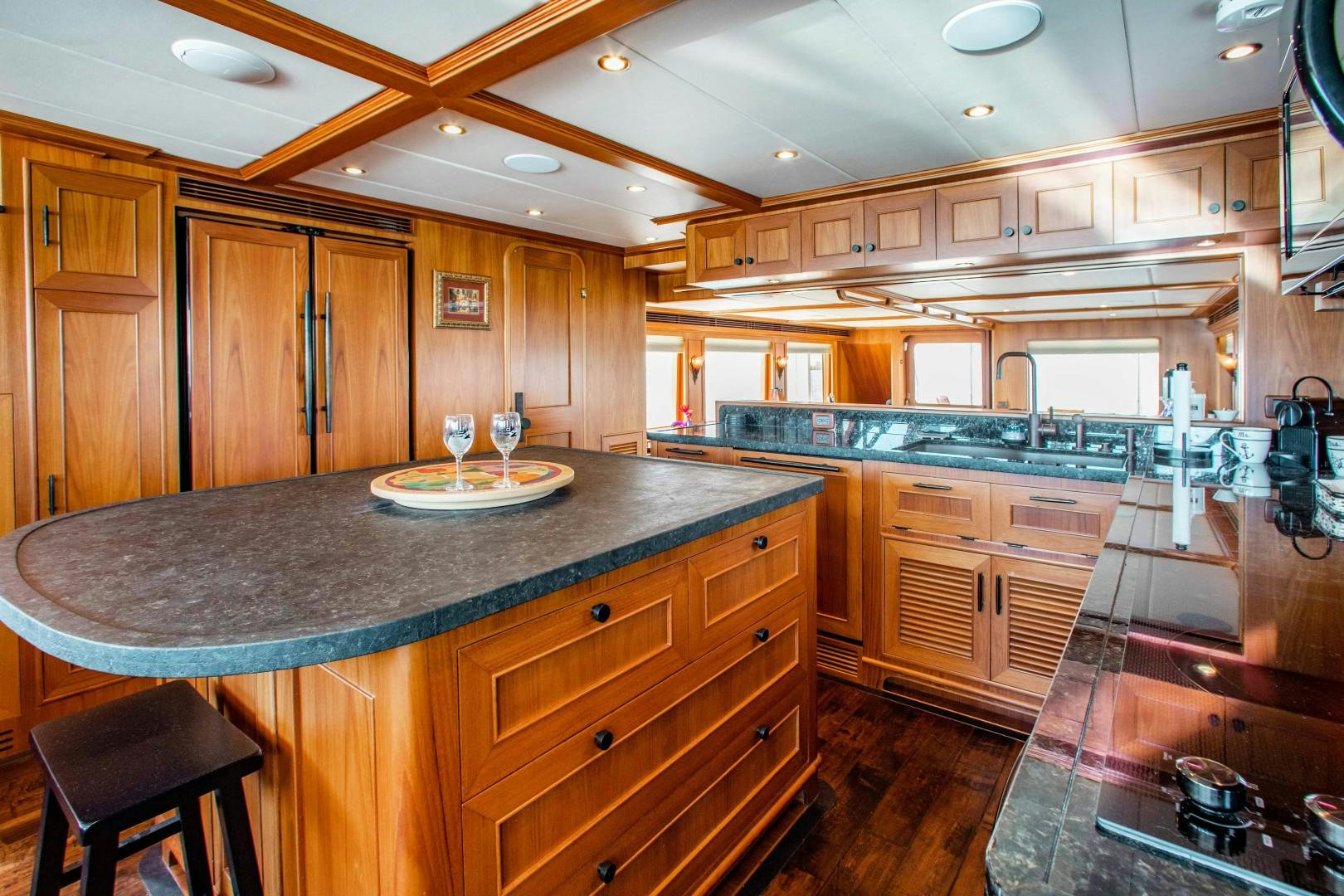 a kitchen with wooden cabinets aboard BARBARA SUE II Yacht for Sale