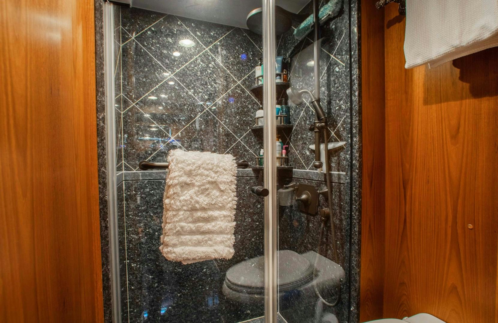 a bathroom with a glass shower aboard BARBARA SUE II Yacht for Sale