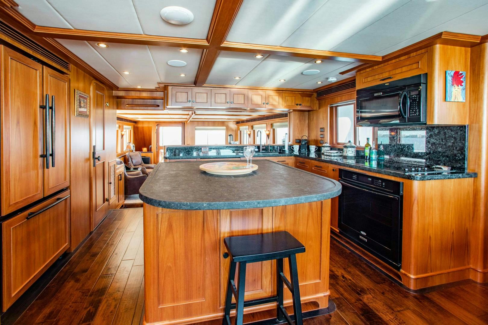 a kitchen with wooden cabinets aboard BARBARA SUE II Yacht for Sale
