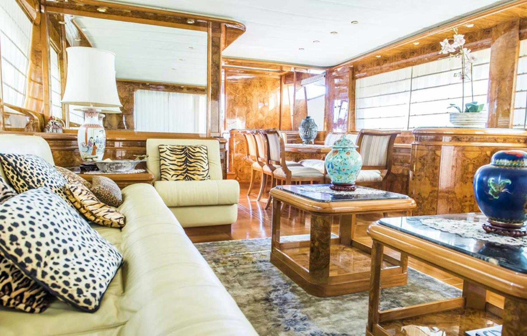 a living room with a couch and a table aboard HEMERA CUARTA Yacht for Sale