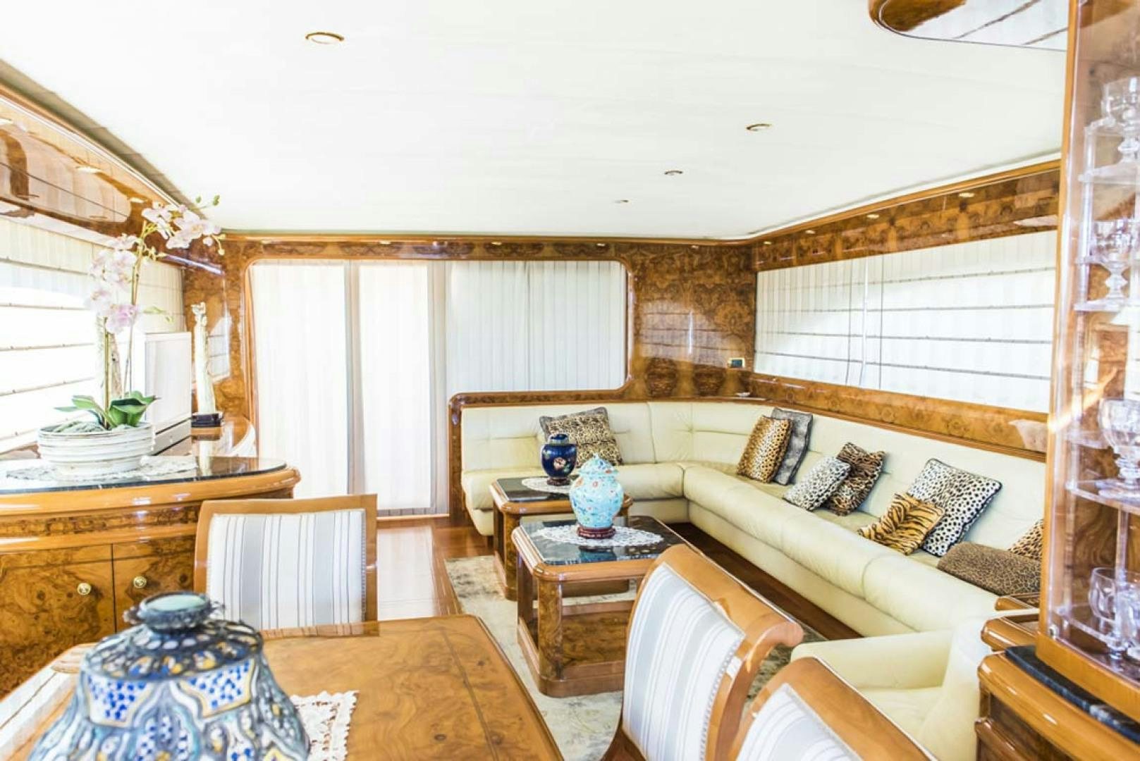 a living room with a couch and a table aboard HEMERA CUARTA Yacht for Sale