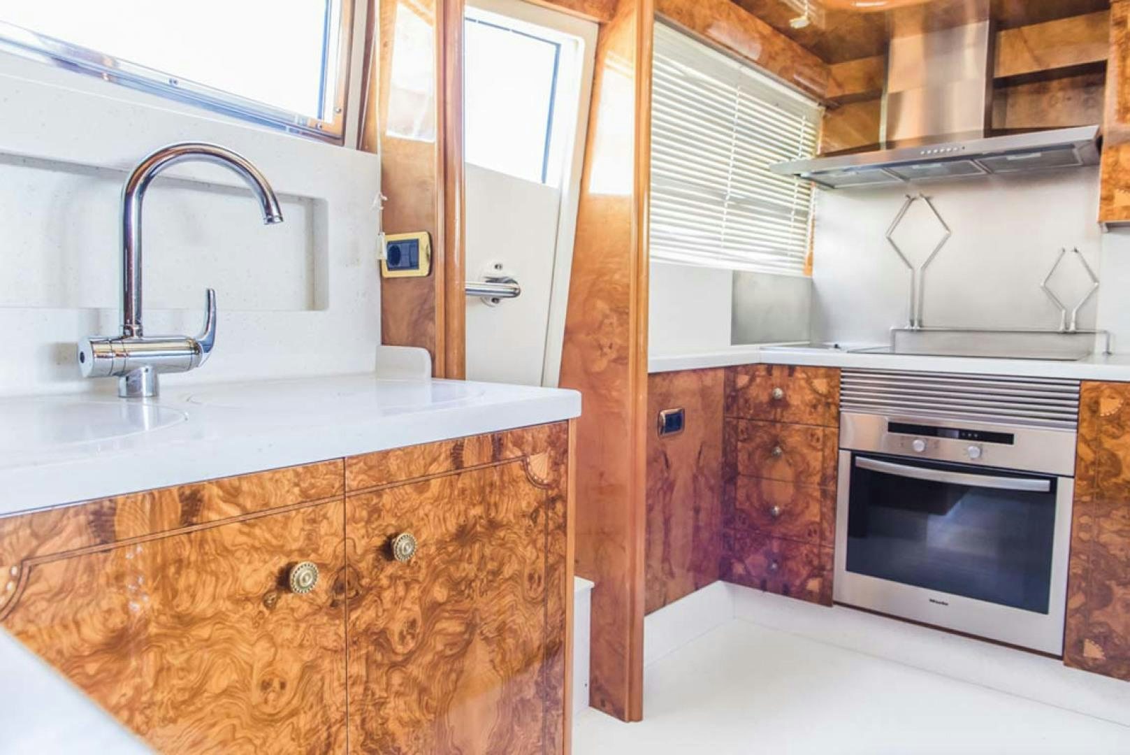 a kitchen with a sink and stove aboard HEMERA CUARTA Yacht for Sale
