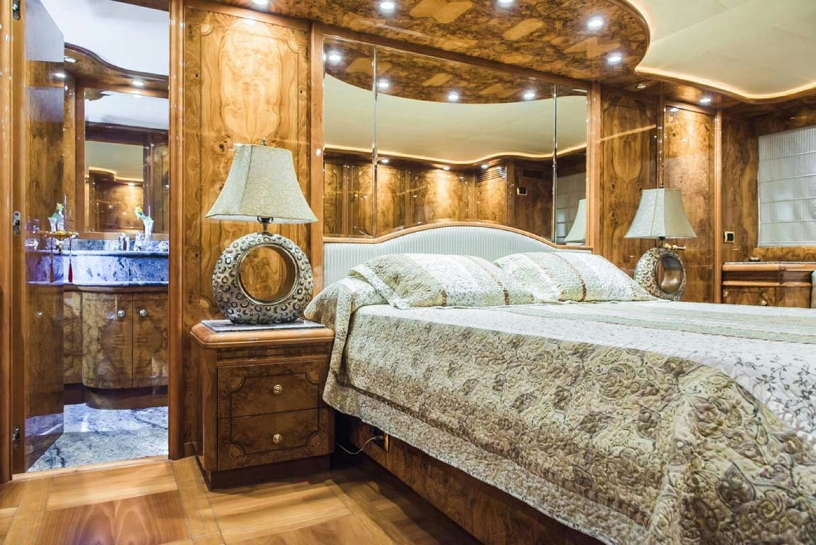 a bed with a lamp on it aboard HEMERA CUARTA Yacht for Sale