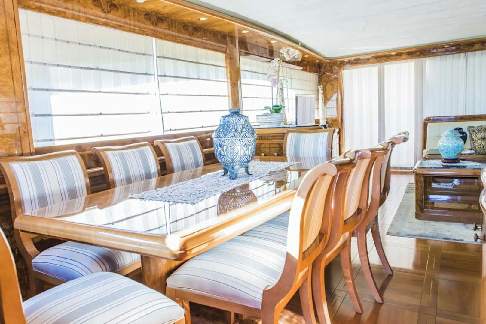 a dining table and chairs in a room aboard HEMERA CUARTA Yacht for Sale
