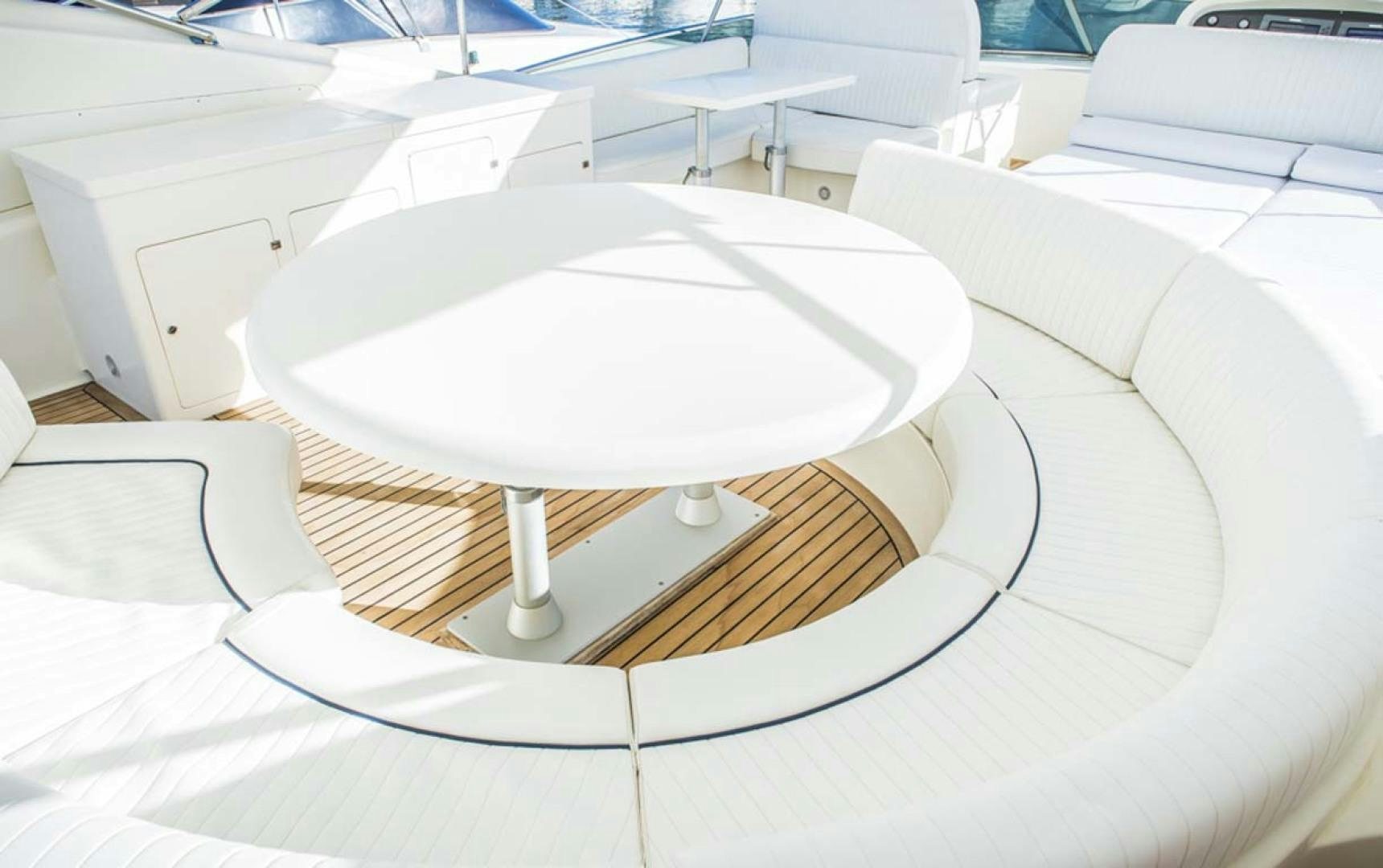 a round white table with a white center aboard HEMERA CUARTA Yacht for Sale