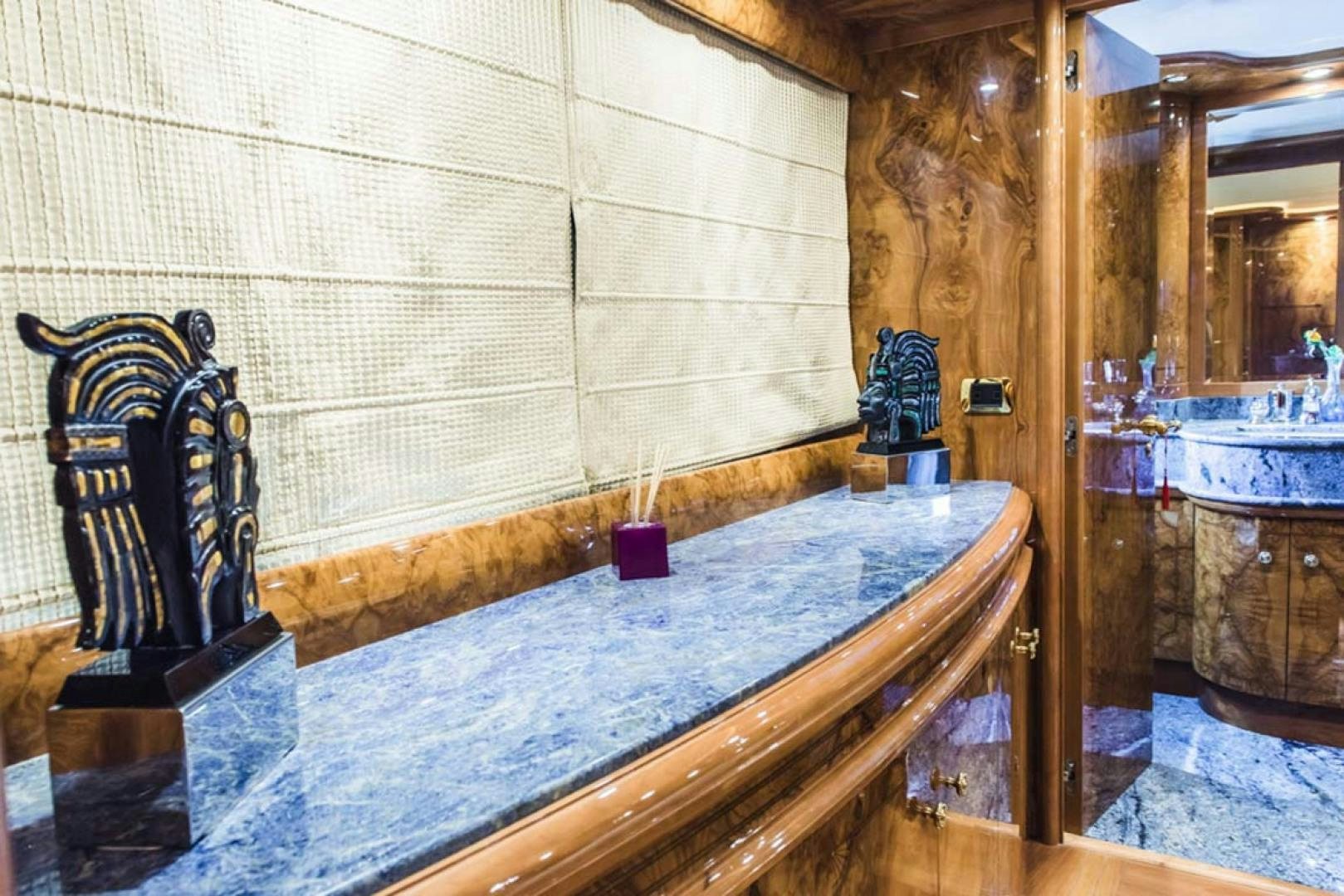 a bed with a chair aboard HEMERA CUARTA Yacht for Sale