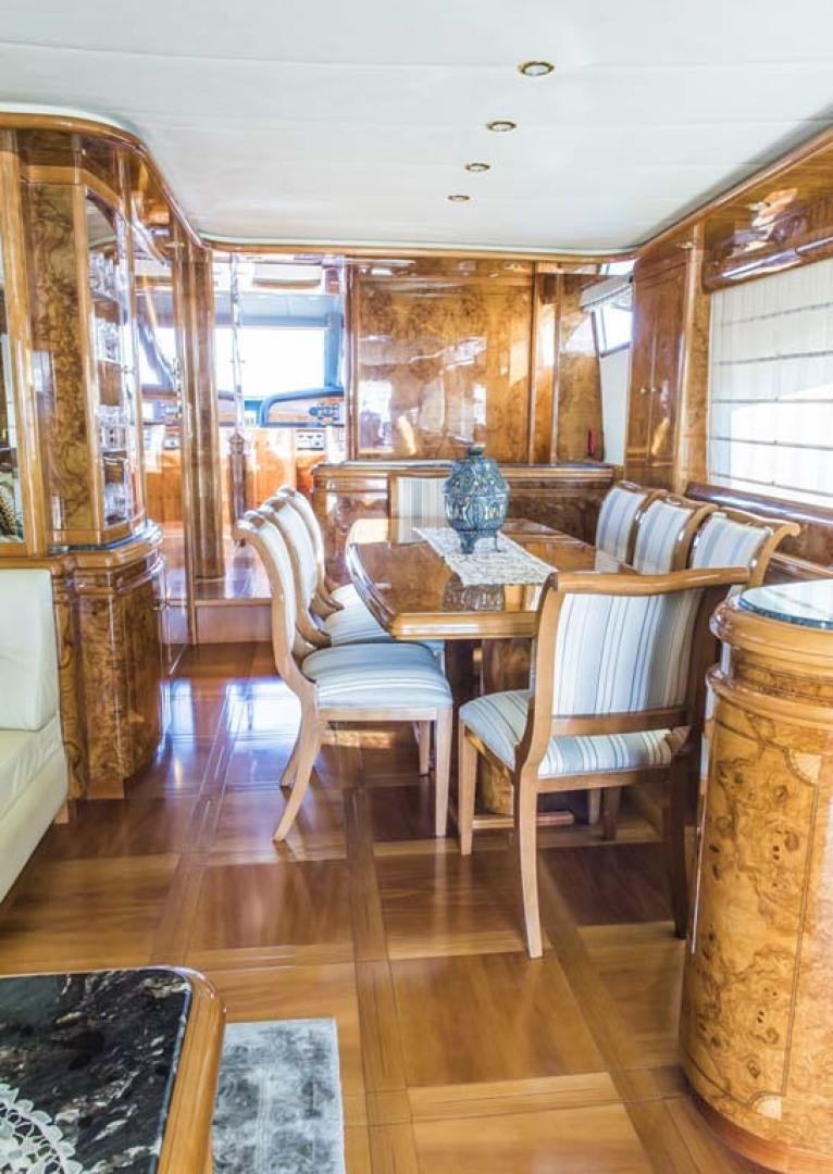 a dining room with wood floors aboard HEMERA CUARTA Yacht for Sale