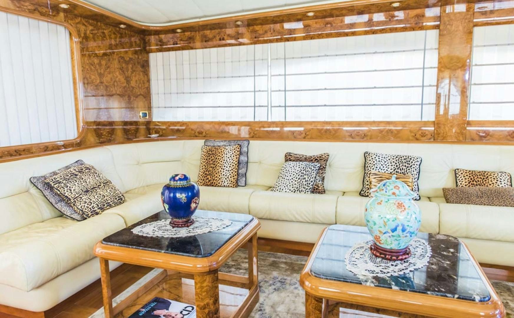 a living room with a couch and a table aboard HEMERA CUARTA Yacht for Sale