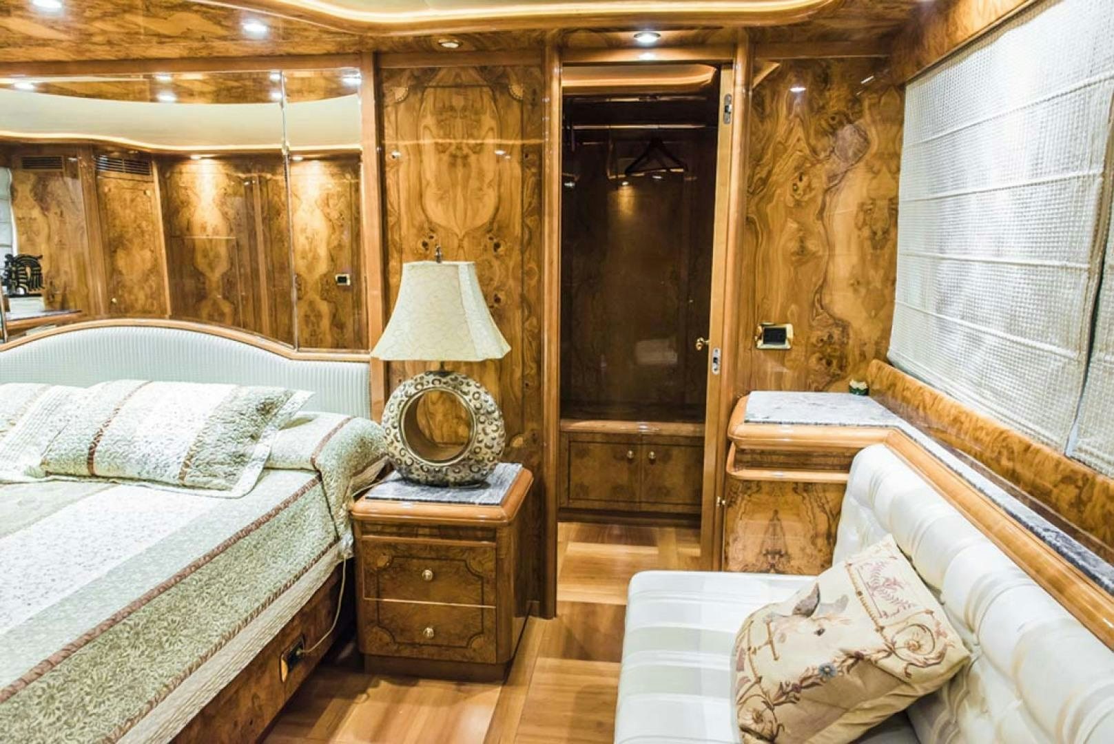 a room with a bed and a lamp aboard HEMERA CUARTA Yacht for Sale