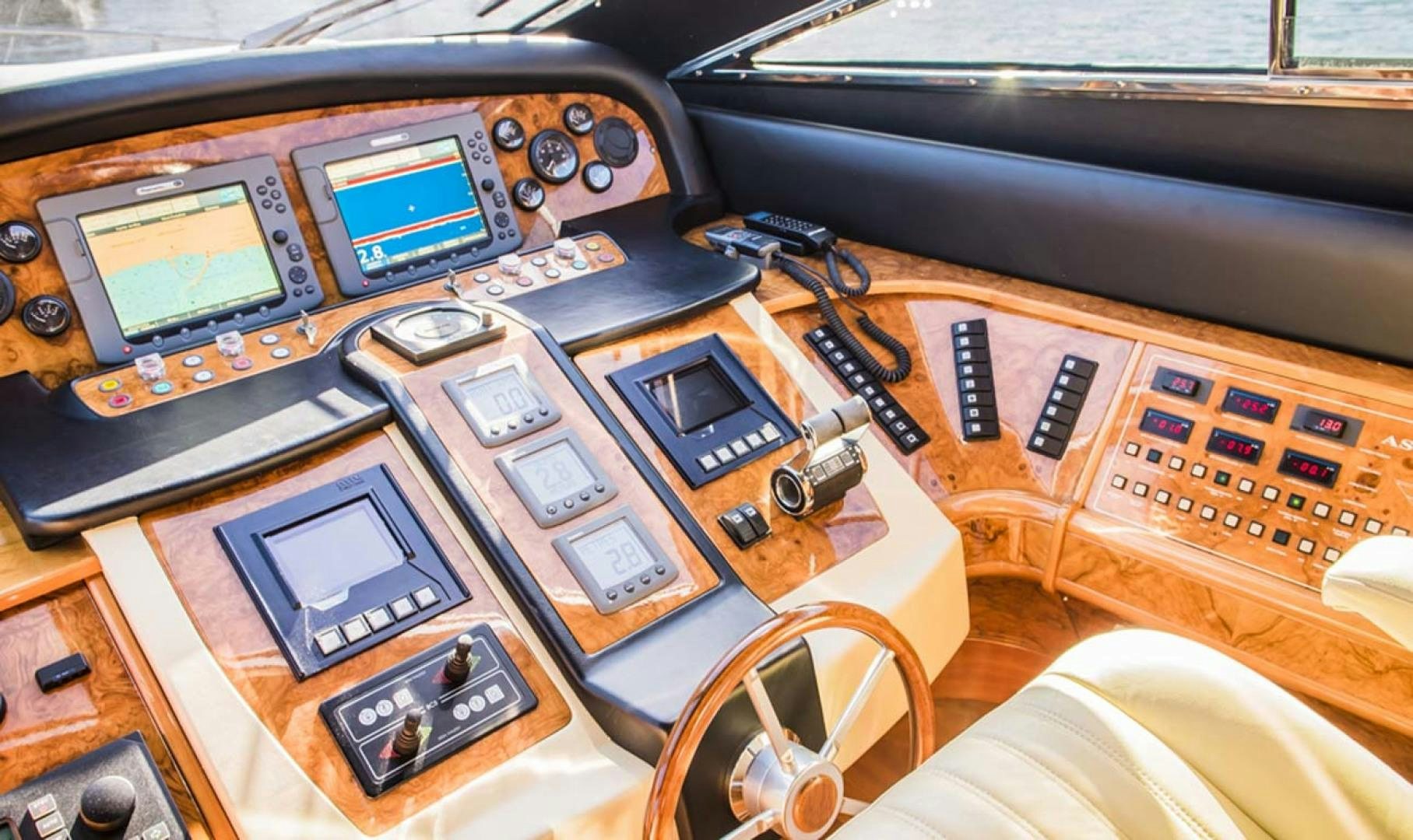 a table with electronics and a laptop aboard HEMERA CUARTA Yacht for Sale