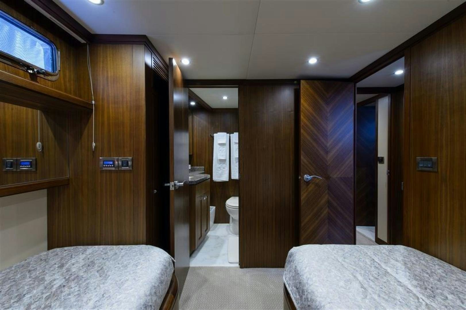 a hotel room with a bed and a closet aboard OCEANA Yacht for Sale