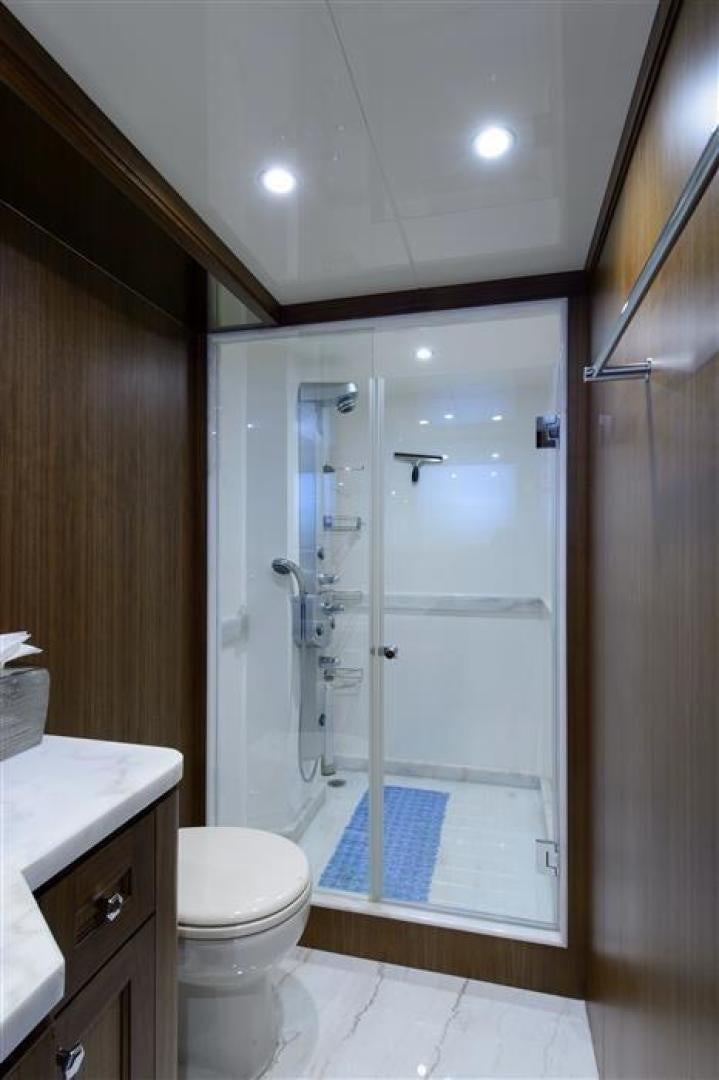 a bathroom with a shower and a toilet aboard OCEANA Yacht for Sale