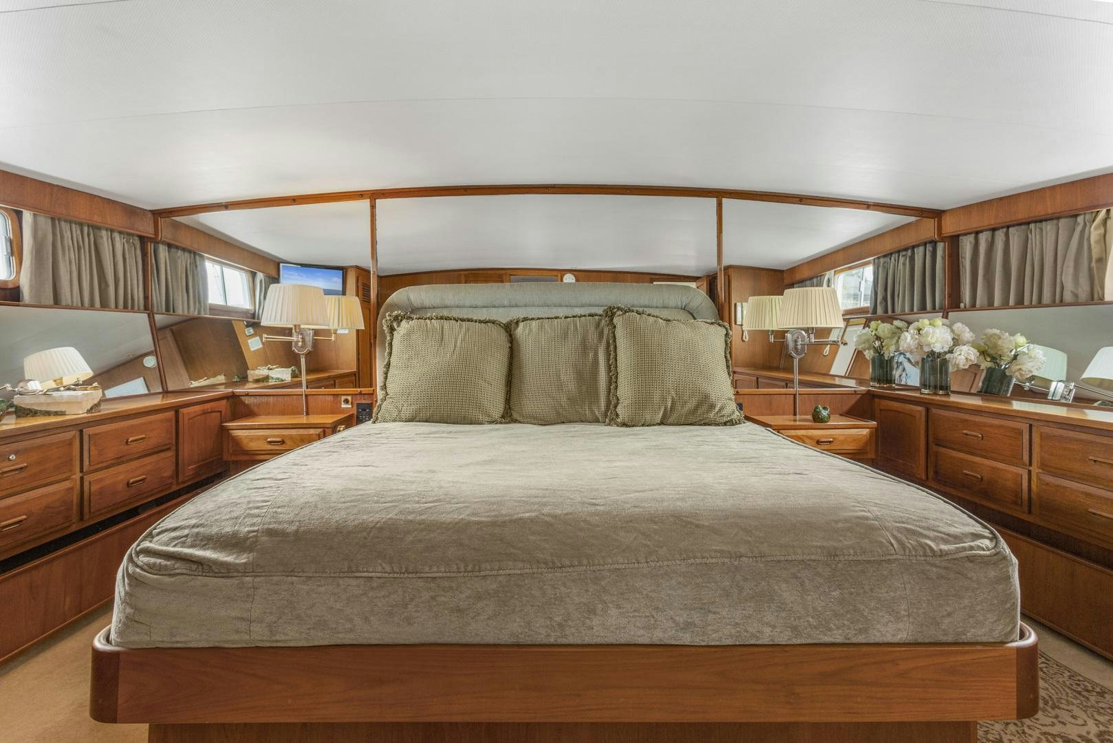 a bed with a brown comforter aboard ELEGANTE Yacht for Sale