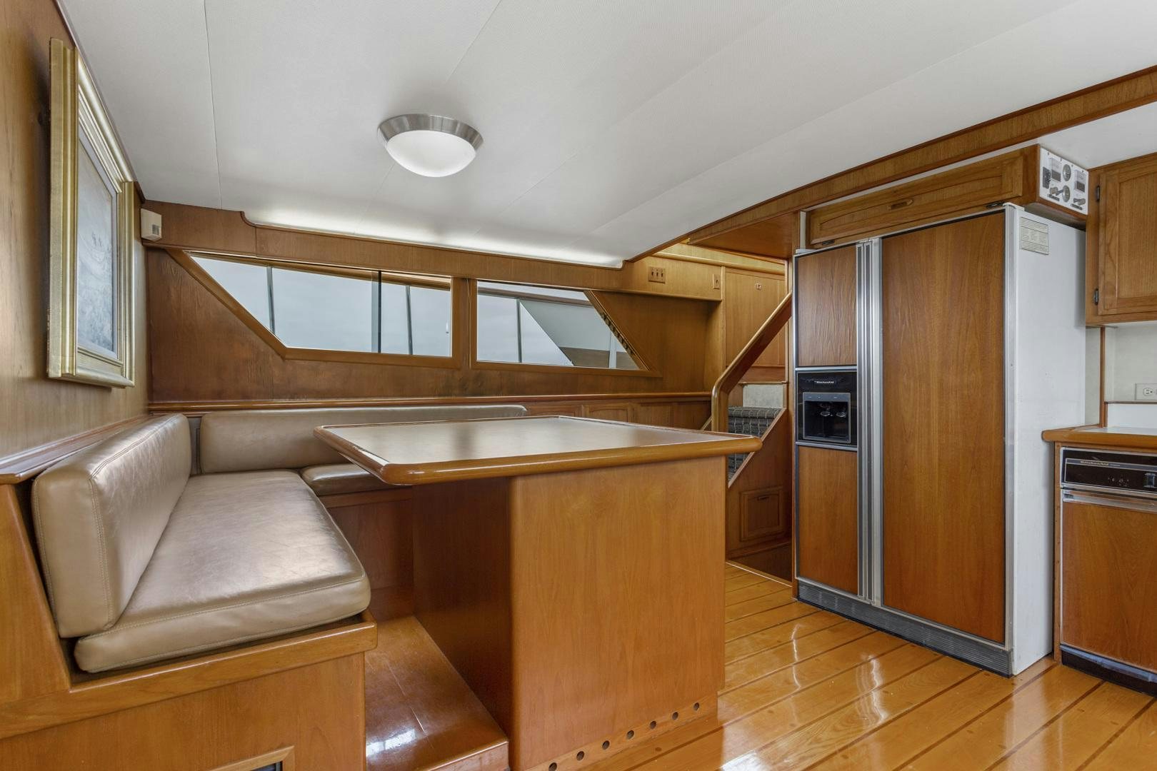 a kitchen with wooden cabinets aboard ELEGANTE Yacht for Sale