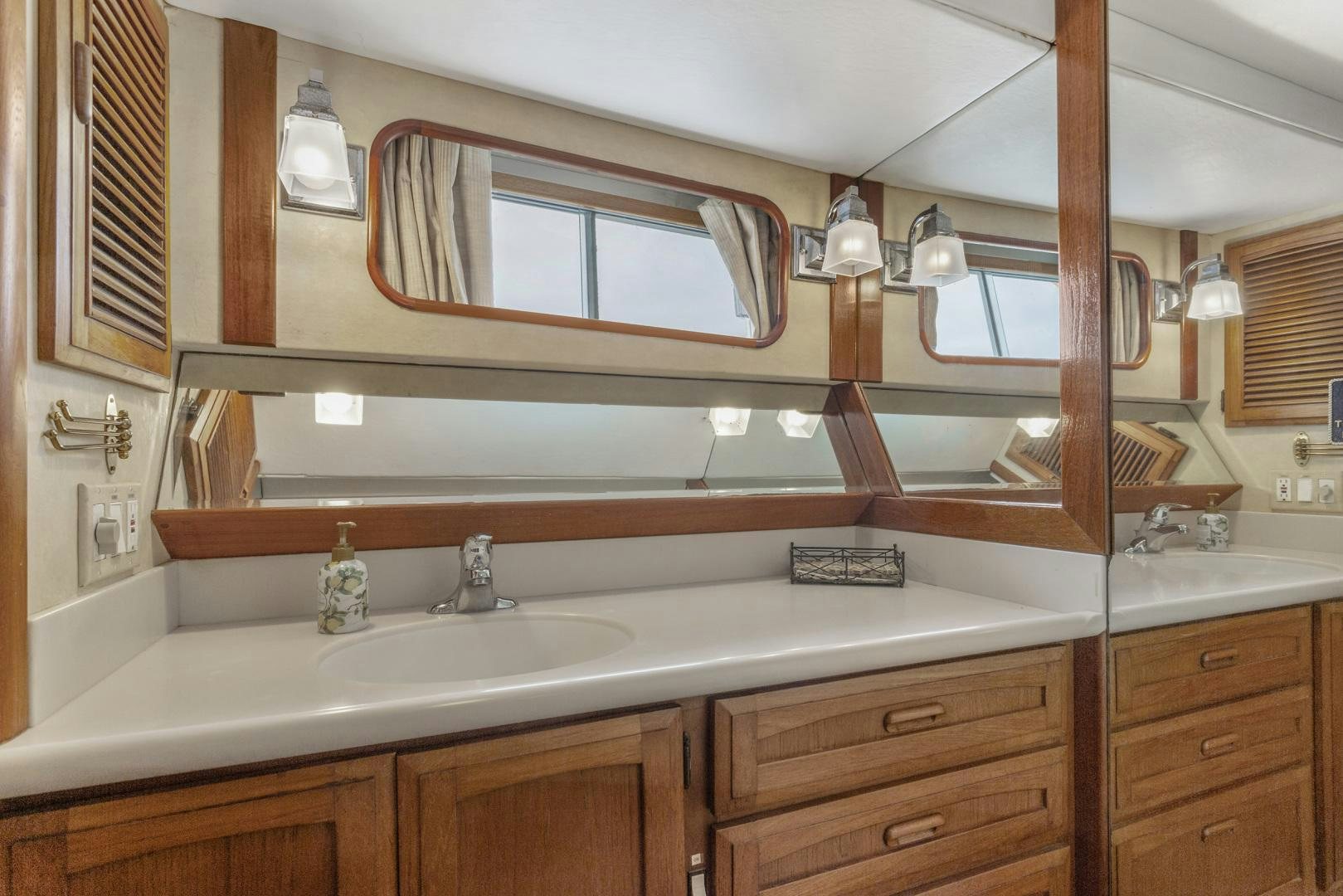 a bathroom with a large mirror aboard ELEGANTE Yacht for Sale
