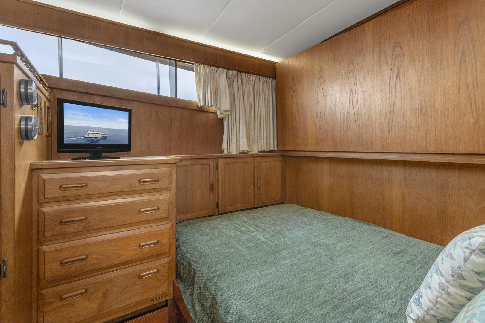 a bedroom with a bed and a television aboard ELEGANTE Yacht for Sale