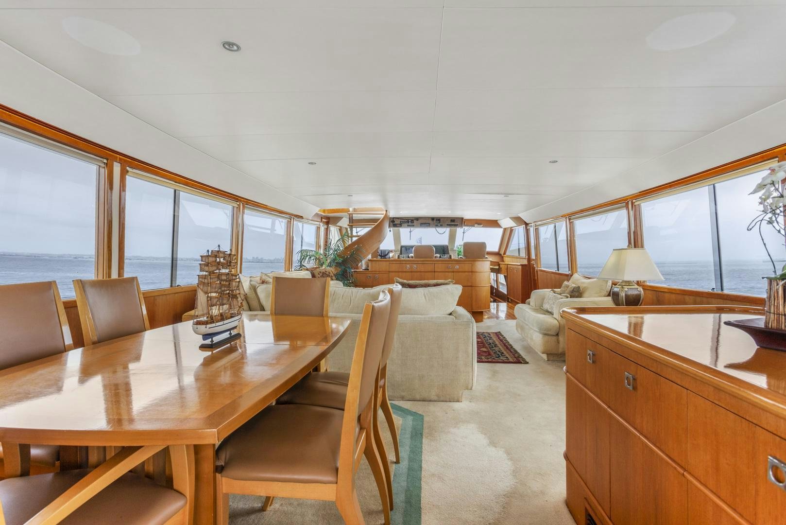 a large room with a table and chairs aboard ELEGANTE Yacht for Sale