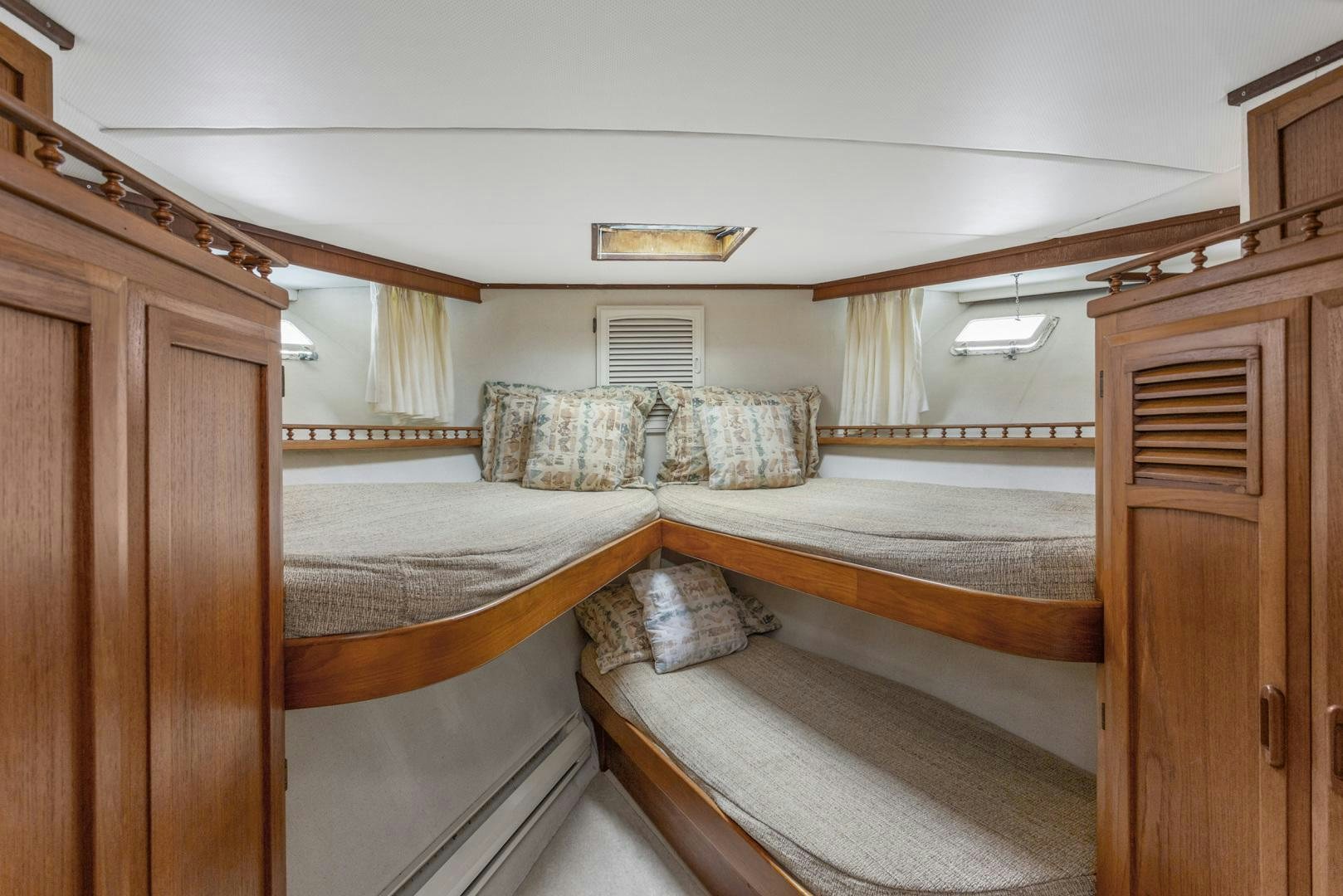 a room with bunk beds aboard ELEGANTE Yacht for Sale