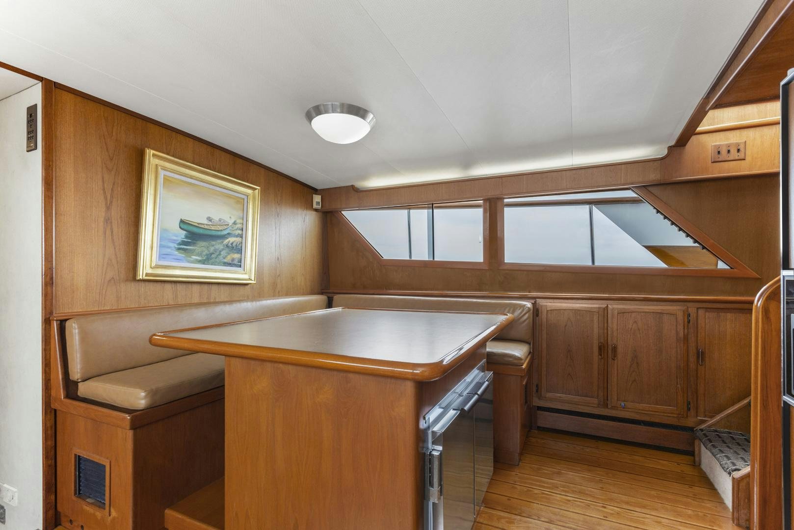 a kitchen with wooden cabinets aboard ELEGANTE Yacht for Sale