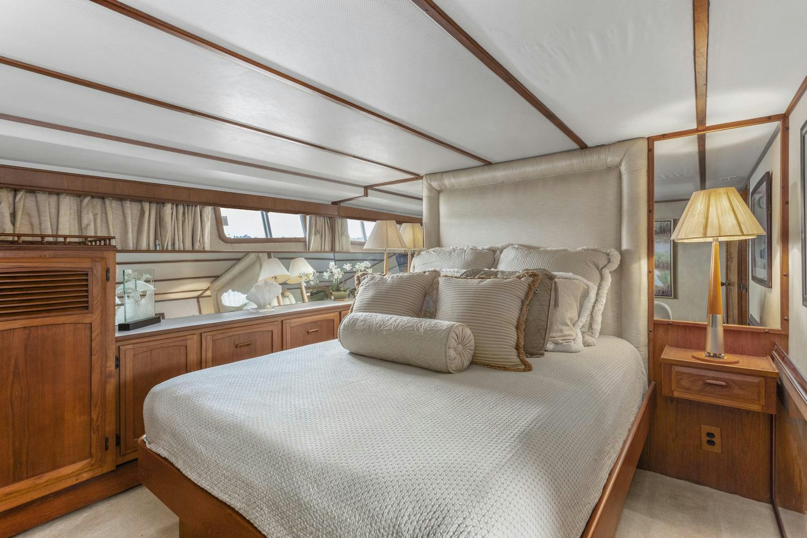 a bed with a lamp on it aboard ELEGANTE Yacht for Sale