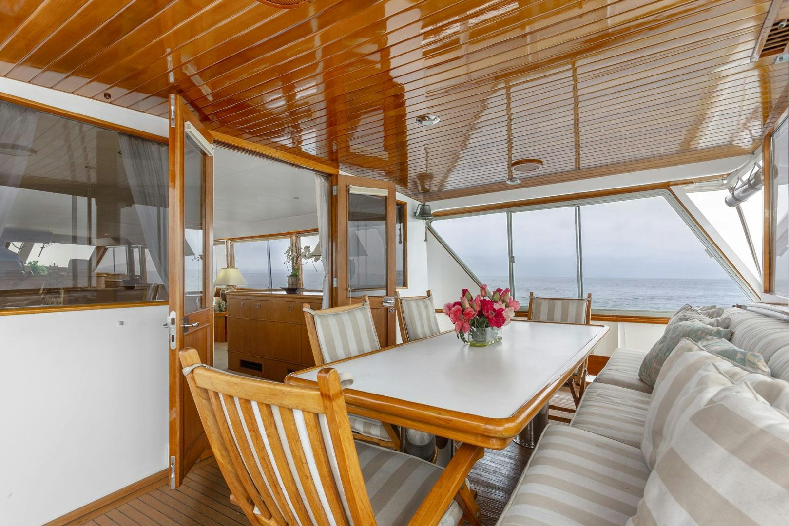 a room with a table and chairs aboard ELEGANTE Yacht for Sale