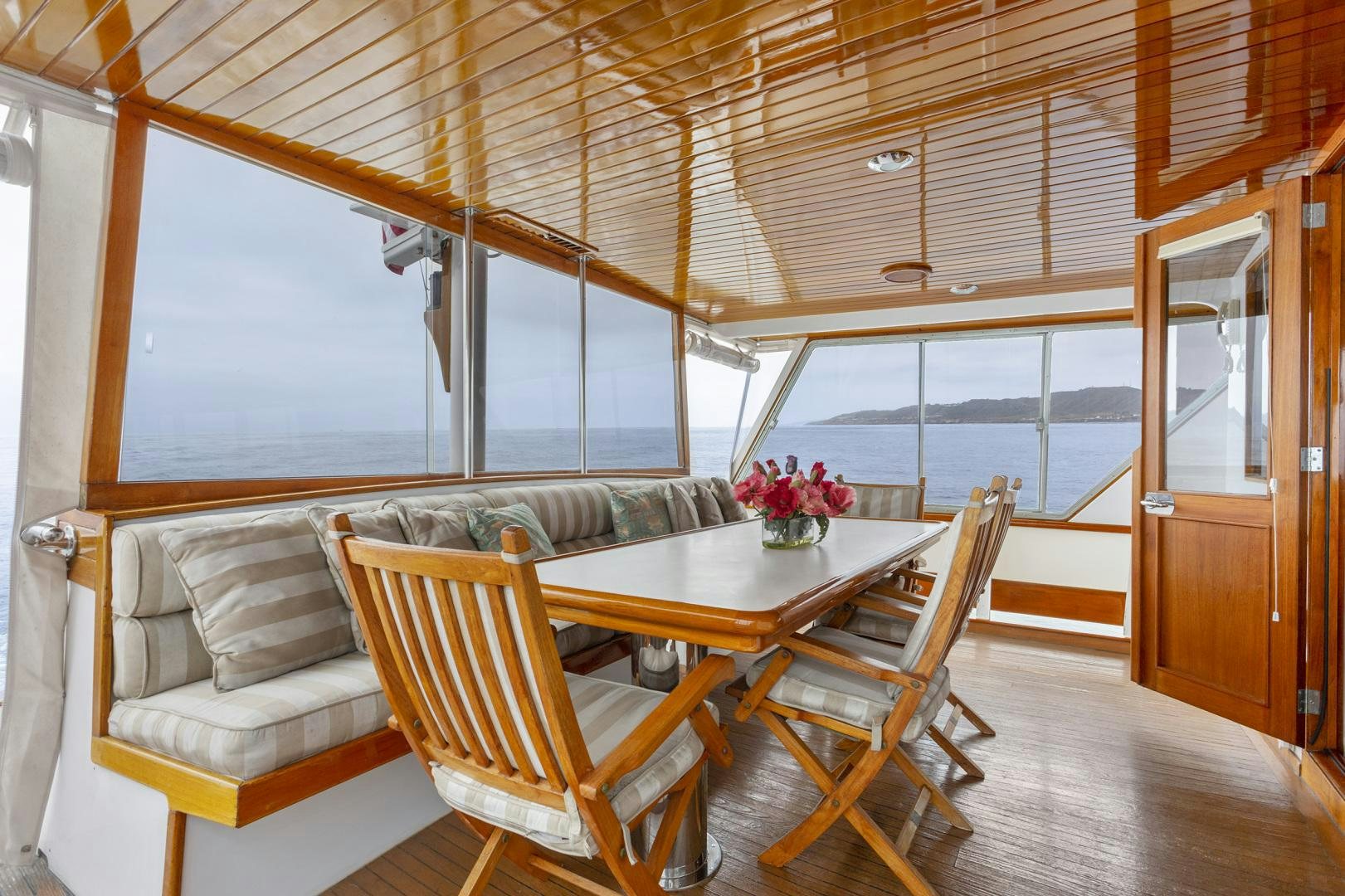 a room with a table and chairs aboard ELEGANTE Yacht for Sale