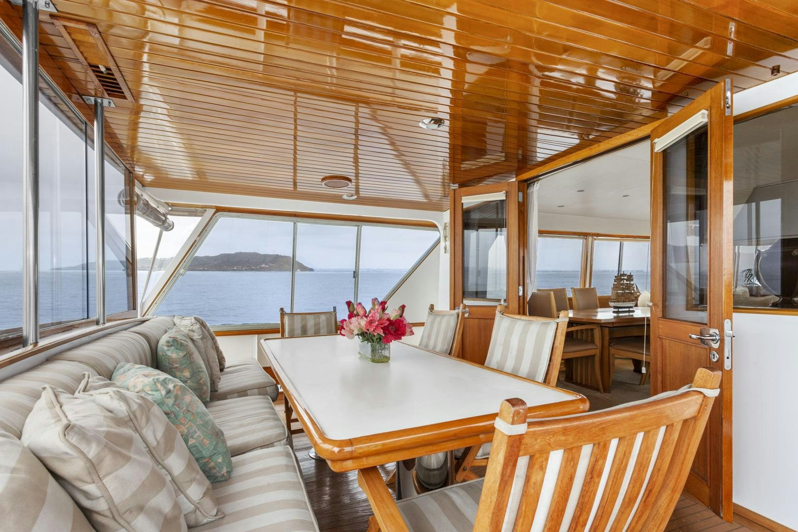 a room with a table and chairs aboard ELEGANTE Yacht for Sale