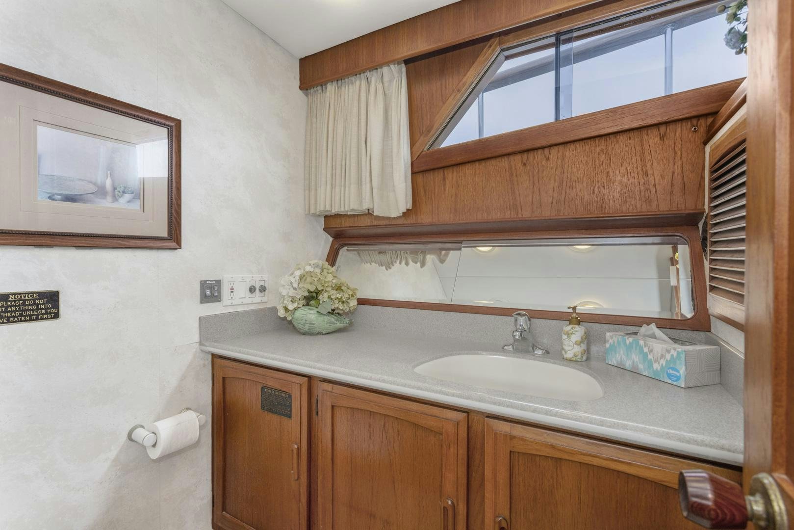 a bathroom with a sink and cabinets aboard ELEGANTE Yacht for Sale