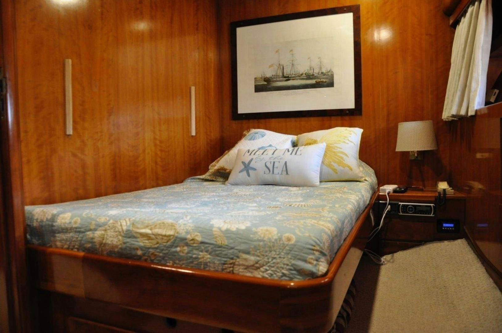 a bed with a blue comforter aboard M.I.S. MOONDANCE Yacht for Sale