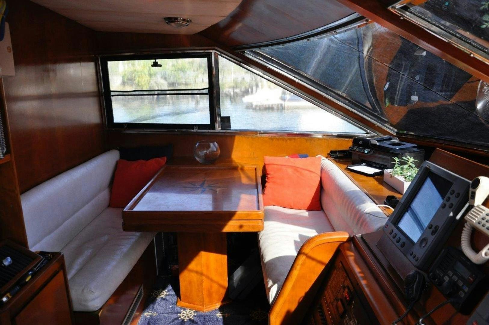 a room with a table and a couch aboard M.I.S. MOONDANCE Yacht for Sale