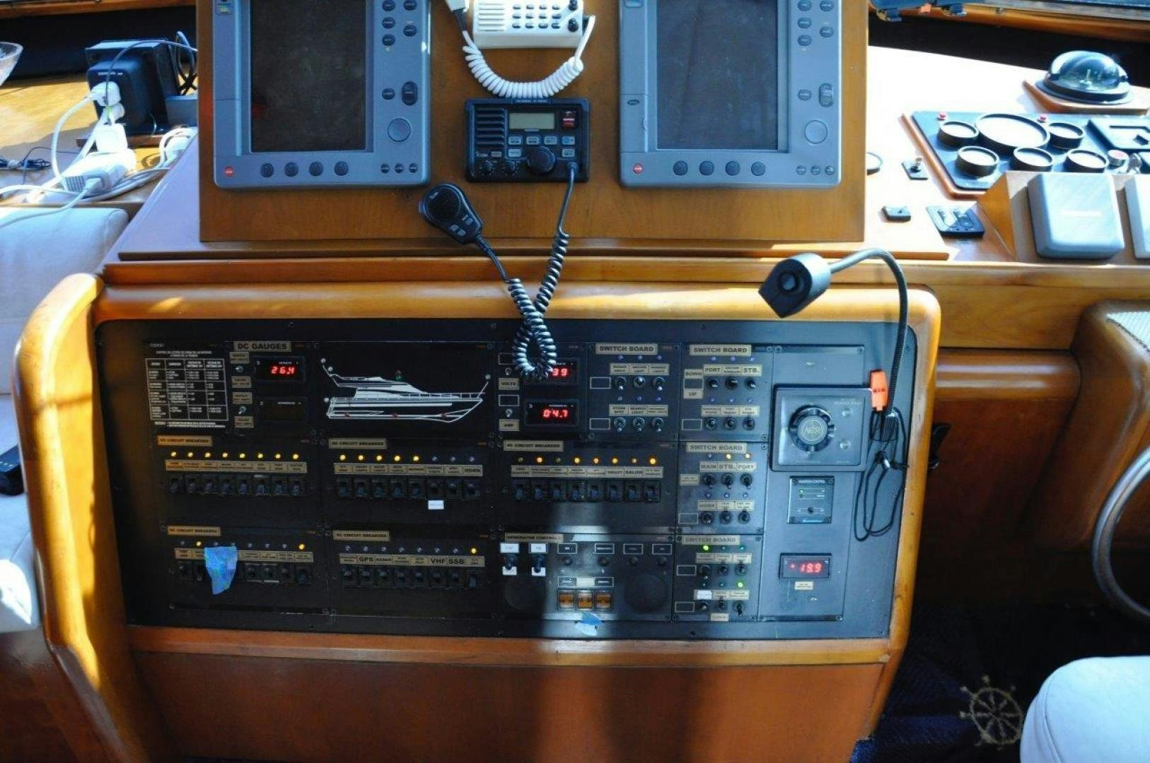 a black electronic device with a wire on a wooden surface aboard M.I.S. MOONDANCE Yacht for Sale