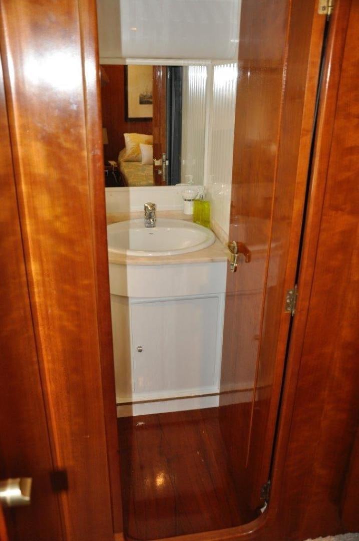 a bathroom with a sink and a mirror aboard M.I.S. MOONDANCE Yacht for Sale