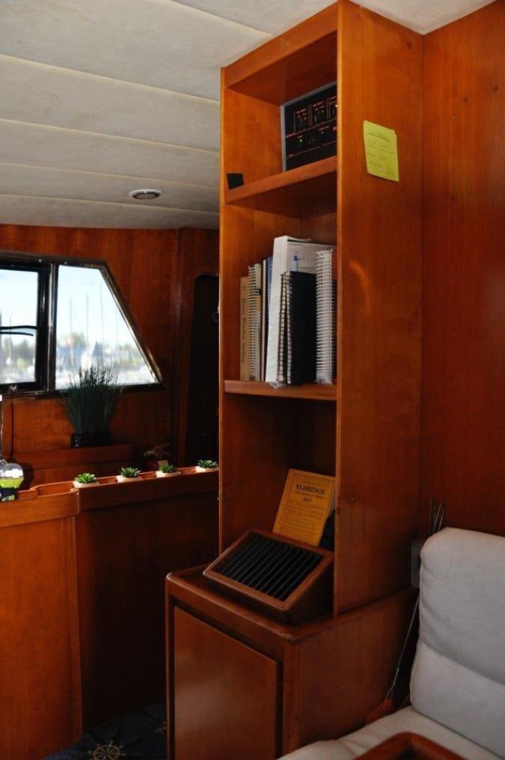 a wooden shelf with books on it aboard M.I.S. MOONDANCE Yacht for Sale