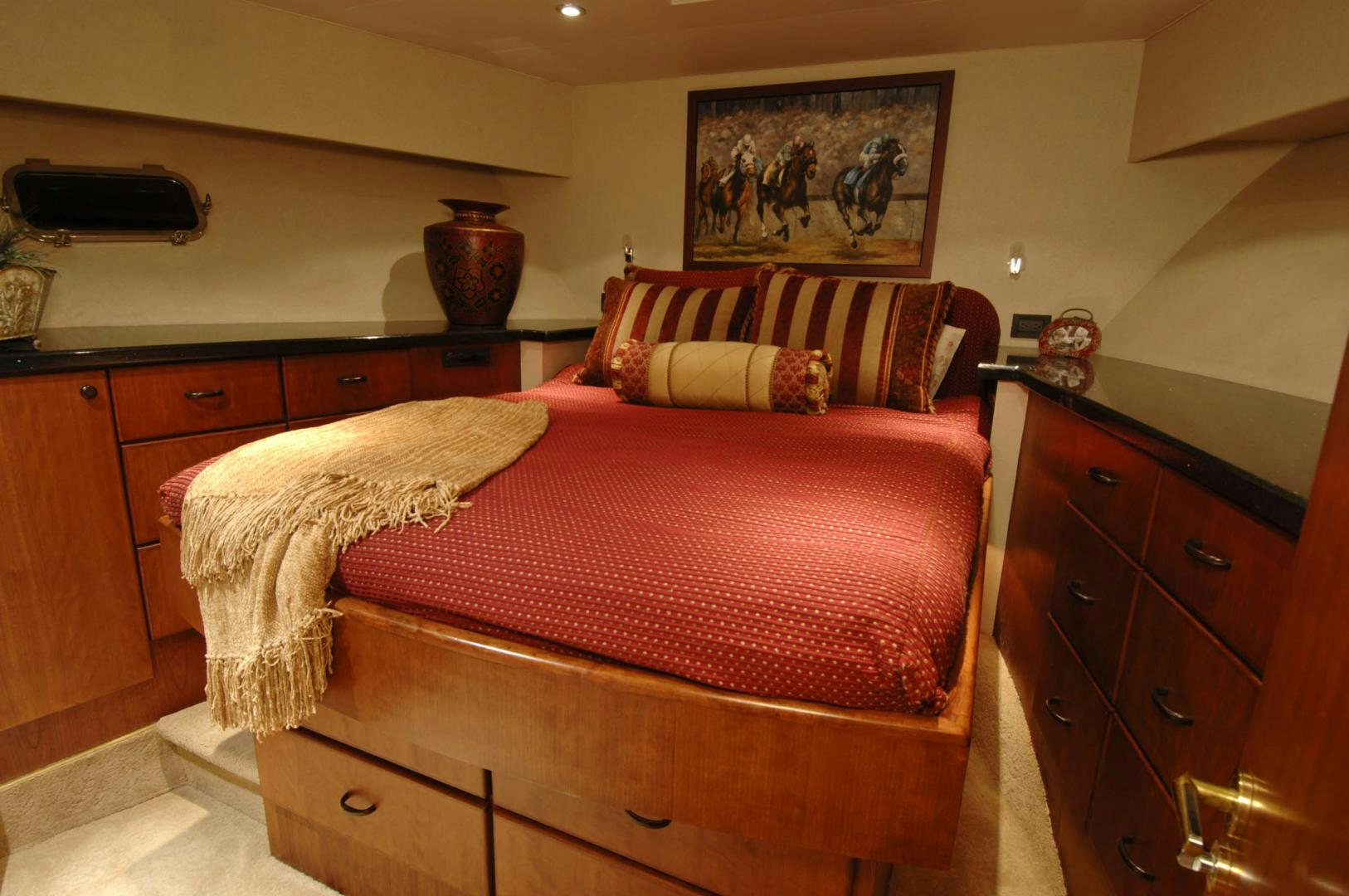 a bed with a red blanket aboard LADY O Yacht for Sale