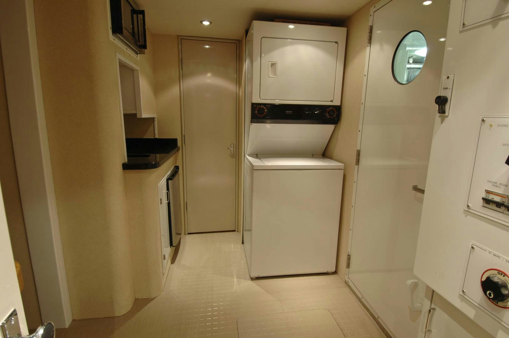 a room with a refrigerator and cabinets aboard LADY O Yacht for Sale