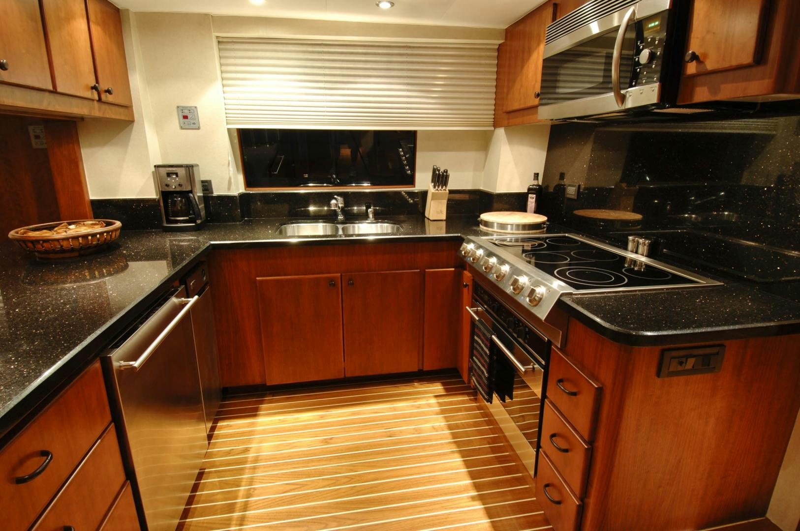 a kitchen with wooden cabinets aboard LADY O Yacht for Sale
