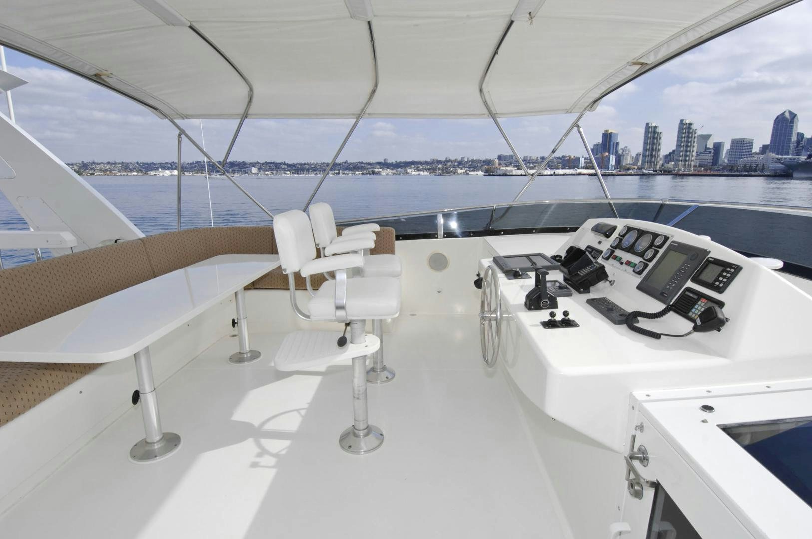 a white table with chairs on it next to a large body of water aboard LADY O Yacht for Sale
